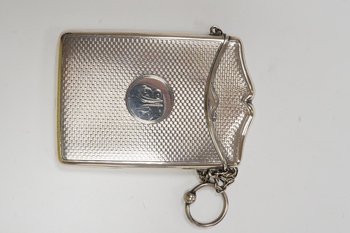 A George V engine turned silver card case, with suspension chain, Synyer & Beddoes, Chester, 1911, 97mm, together with a silver mounted purse, with suspension chain.